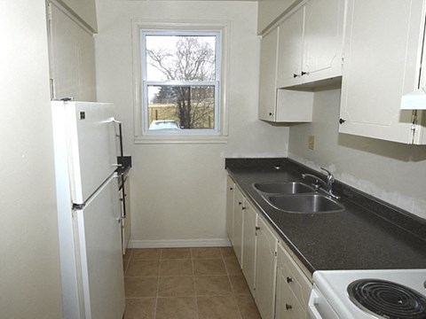 a kitchen with a sink and a refrigerator